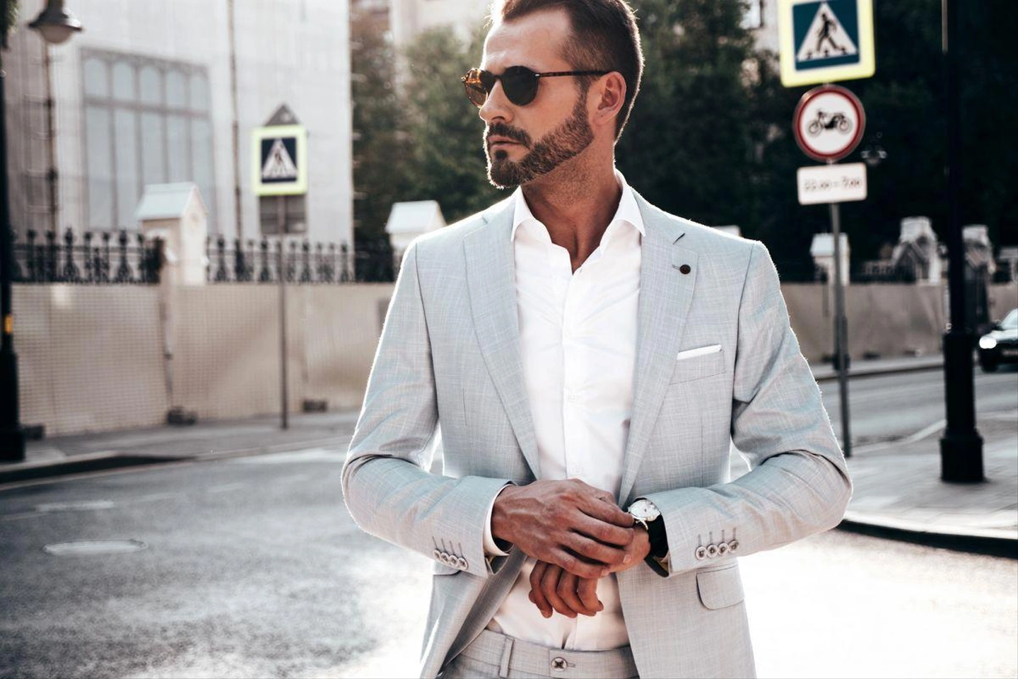 portrait-handsome-confident-stylish-hipster-lambersexual-modelmodern-man-dressed-elegant-white-suit-fashion-male-posing-street-background-europe-city-sunset-sunglasses.jpg