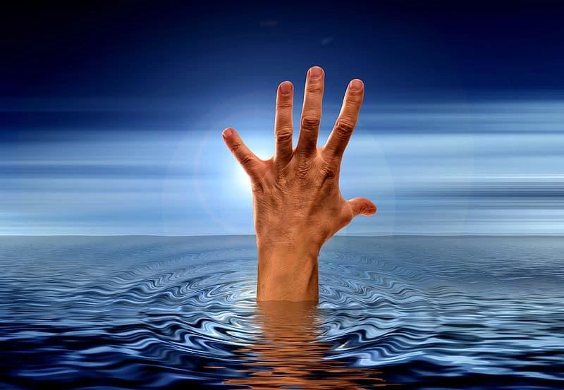 photo-of-human-hand-on-body-of-water.jpg